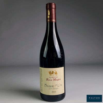 a close up of a bottle of red wine on a table