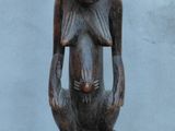 an image of a wooden statue of a man with a hat on