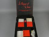 an open box containing a game of dice and cards on a table