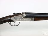 a rifle with a wooden barrel and a metal handle
