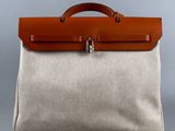 a brown and white bag sitting on top of a gray surface