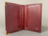 an image of a red leather wallet with a gold clasp