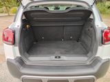 the back of a car with its trunk open in a parking lot