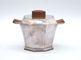 a silver pot with a wooden lid on a white surface