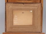 an old picture of a wooden box with a painting inside of it