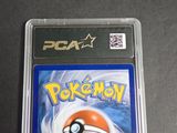 the pokemon card is in a plastic case on a table