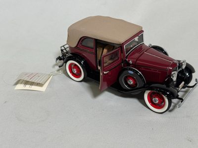 a toy car that is sitting on a white surface