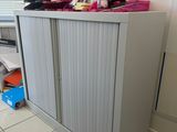 a cabinet that has a bunch of items on top of it