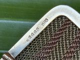 a close up of a metal mesh with a metal handle
