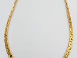 an image of a gold necklace on a white background