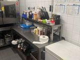 a kitchen with a refrigerator, stove, and counter top