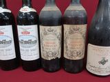 several bottles of wine are lined up in a row on a table