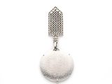 a close up of a pair of earrings on a white surface