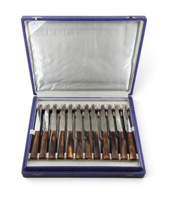 a set of six knives in a blue case on a white background