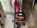 an orange and black vacuum cleaner sitting on top of a hard wood floor