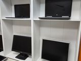a desk with two monitors and a laptop on it
