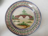 a plate with a picture of a bridge on it