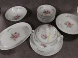 a lot of plates and bowls that are on the table