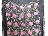 an image of a black scarf with pink flowers and fringes