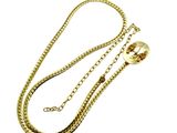 a close up of a gold chain with a ball on it