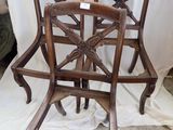 pair of antique carved wood dining chairs with arms and backs