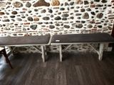 a bench that is sitting in front of a stone wall