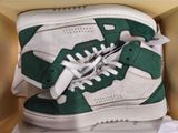 a pair of green and white sneakers in a box