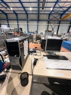 a desk with a computer, keyboard, mouse, and monitor on it