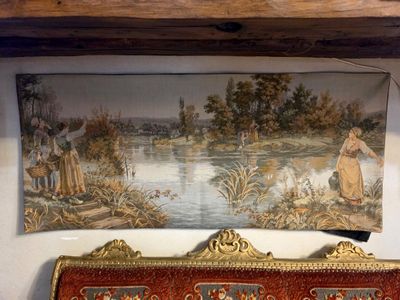 a painting on the wall above a couch in a room