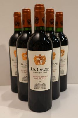 six bottles of wine are lined up on a table