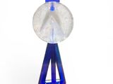 blue and clear crystal pendant with a blue ribbon on a white background
