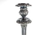 a silver candle holder with a lion head on top of it