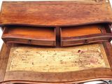 a wooden desk with a drawer on top of it
