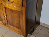 a wooden cabinet with a marble top on a tiled floor