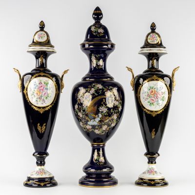 three black and gold vases with floral designs on them on a white background
