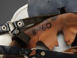 a close up of a baseball glove and a baseball bat