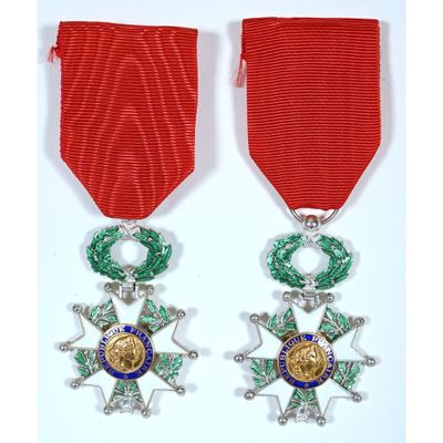a pair of medals with a red ribbon and a star