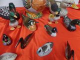 many ducks that are sitting on a table