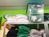 a shelf with a lot of clothes on it in a store