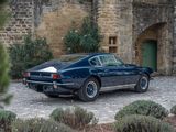 a blue sports car parked in front of a stone building