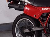 a red and black motorcycle parked in a garage