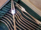 a lot of spoons in a case on the table