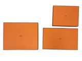 three pieces of orange leather with a white background