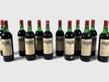 six bottles of wine are lined up in a row on a white surface