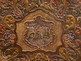 an ornately decorated wooden panel with a picture of a group of people on it