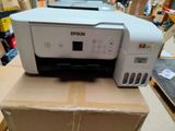 a printer sitting on top of a box in a warehouse