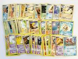 a lot of pokemon cards sitting on a table