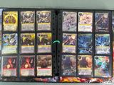 a lot of cards in a binder on the table