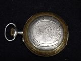 a silver pocket watch on a black surface