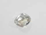 a close up of a white diamond on a white surface